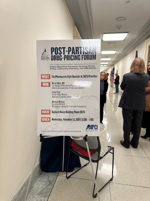 A sign advertising APCI's Drug Pricing Forum for Congressional members