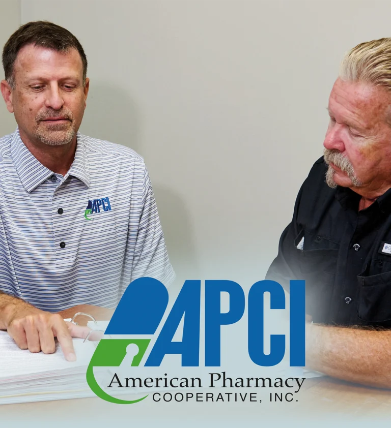 APCI Vice President of Sales Mark Million discusses a report with APCI member Jim Gibbs of Gibbs Pharmacy