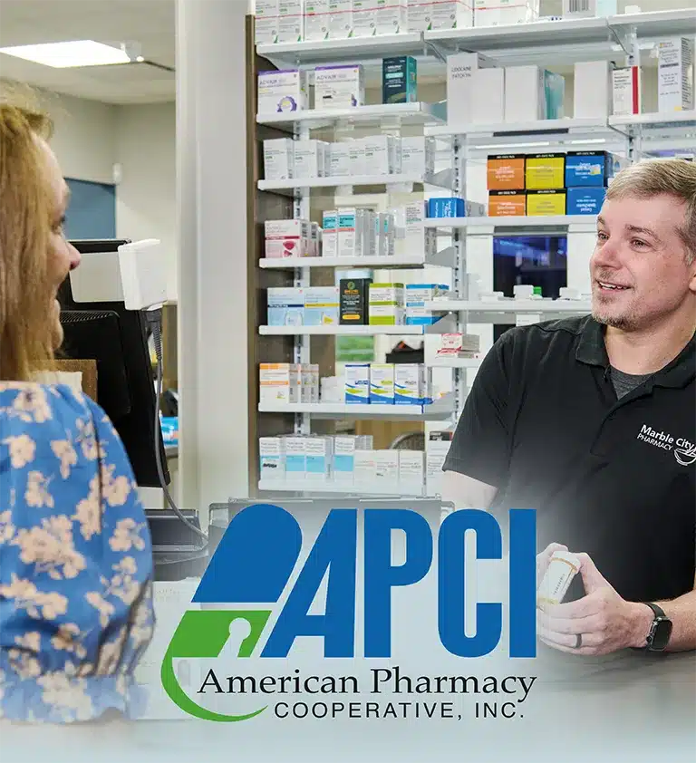 Pharmacist Jacob Johnson counsels a female patient at APCI member Marble City Pharmacy